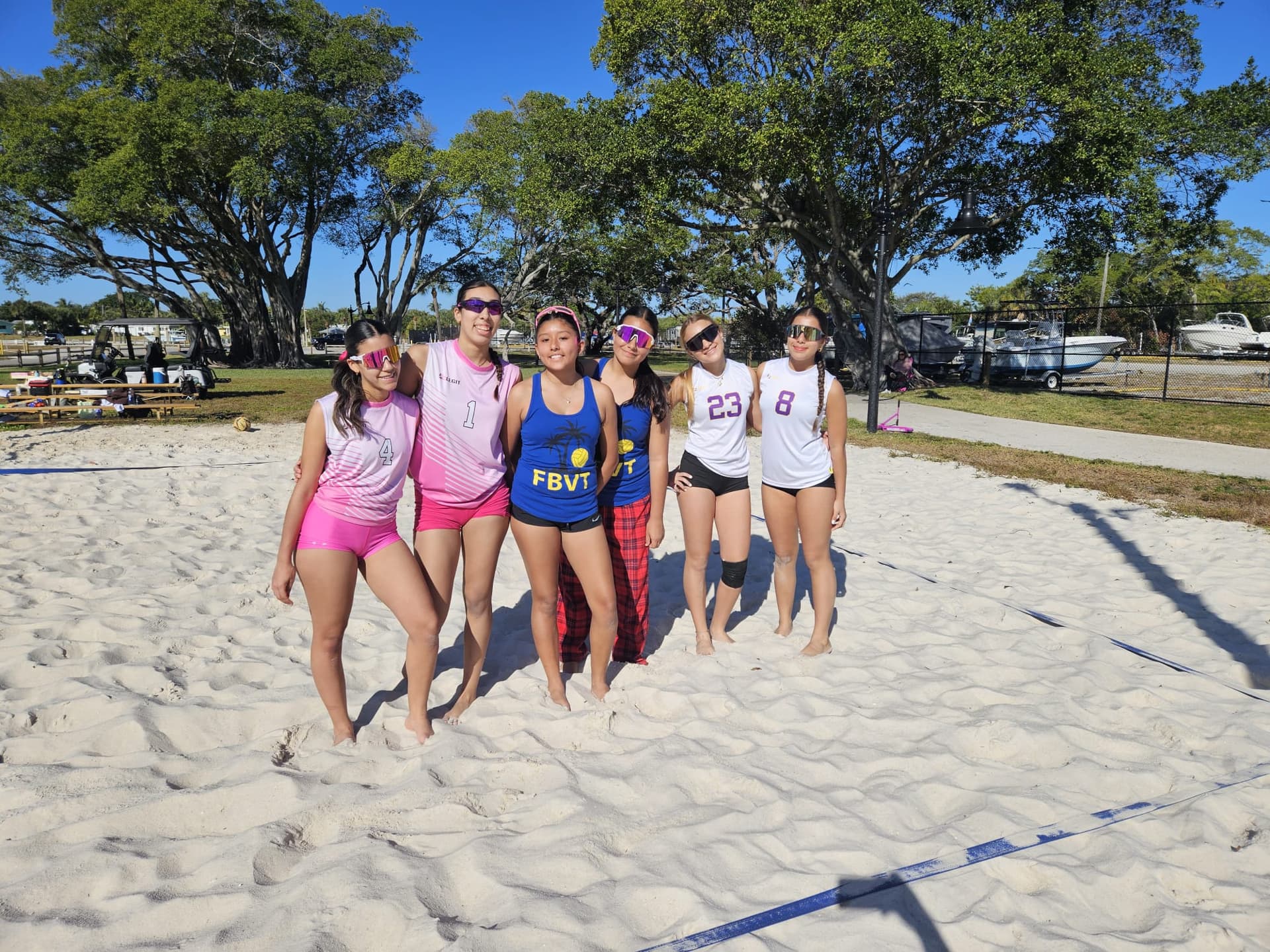 Youth volleyball players learning fundamentals in Miami training program